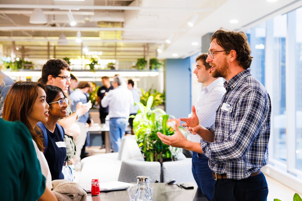 KBR colleagues chatting at an office networking event