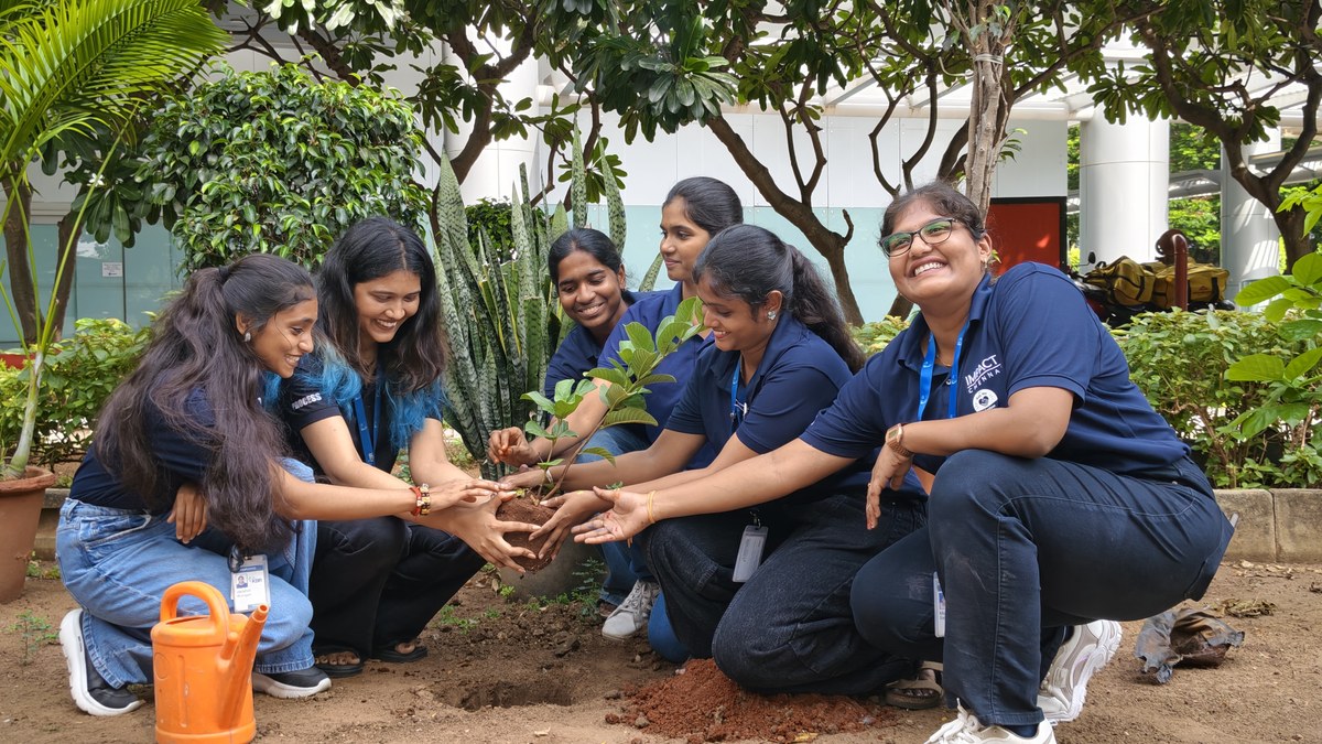 KBR India team planting a tree together during a community sustainability initiative