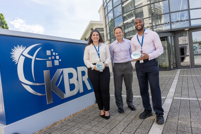 KBR UK colleagues holding KBR Future Talent Class of 2026 awards outside the Leatherhead office