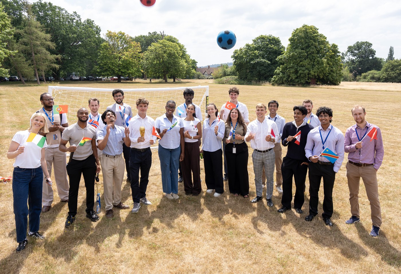 KBR UK and Europe team at a culture and social event, each holding a national flag