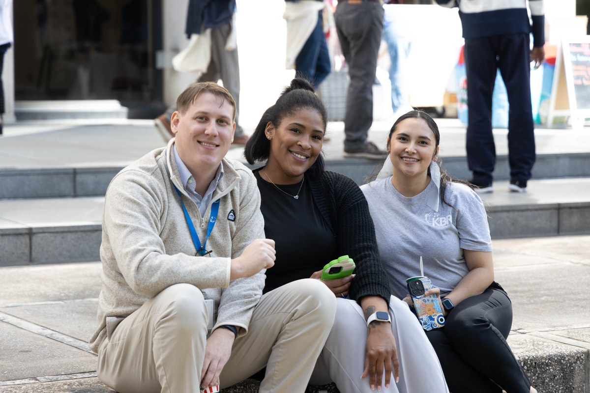 KBR colleagues sitting together outdoors during a company outing
